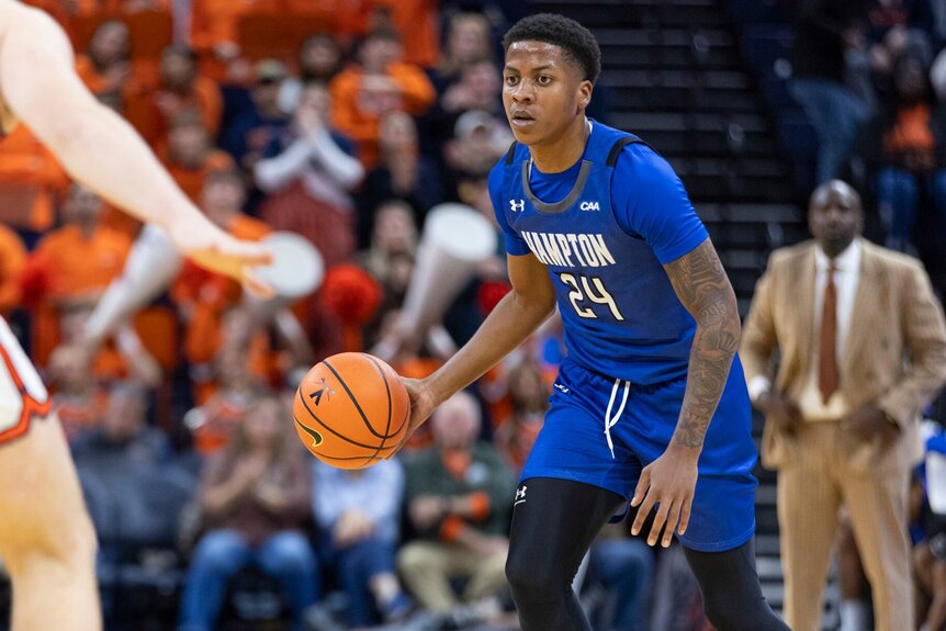Quintin Cooper, #24 of the Hampton Pirates, dribbles the ball against the Virginia Cavaliers.