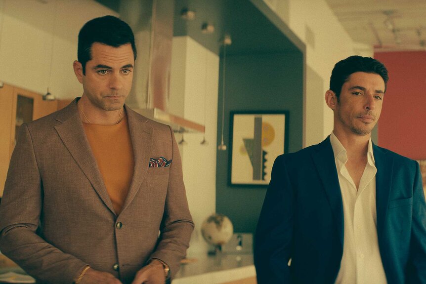 Samuel and Elias standing next to each other in M.I.A. Season 1 Episode 2.