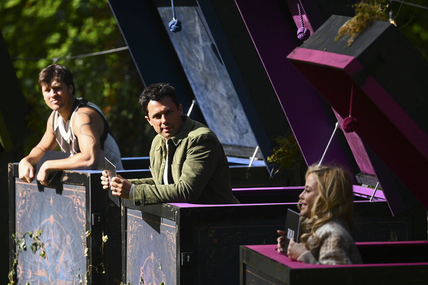 Rob Rausch, Stephen Colletti, and Tara Lipinski popping out of boxes in The Traitors Season 4 Episode 9.