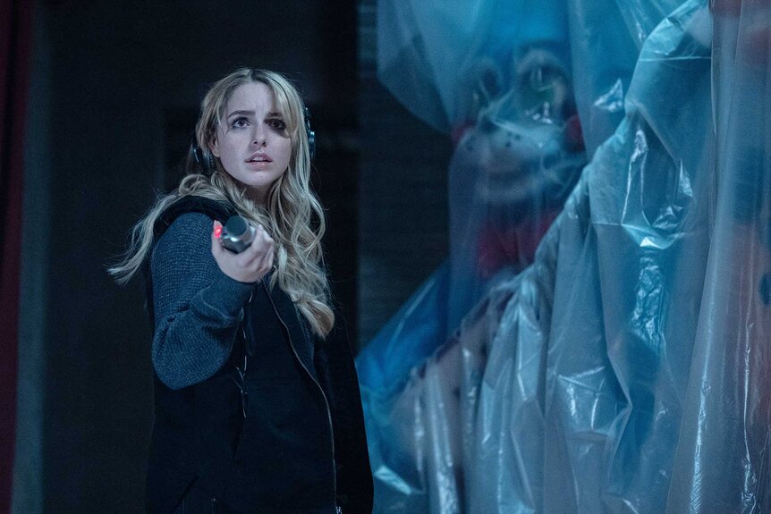 Lisa looking at the animal animatronics in Five Nights at Freddy's 2 (2025).