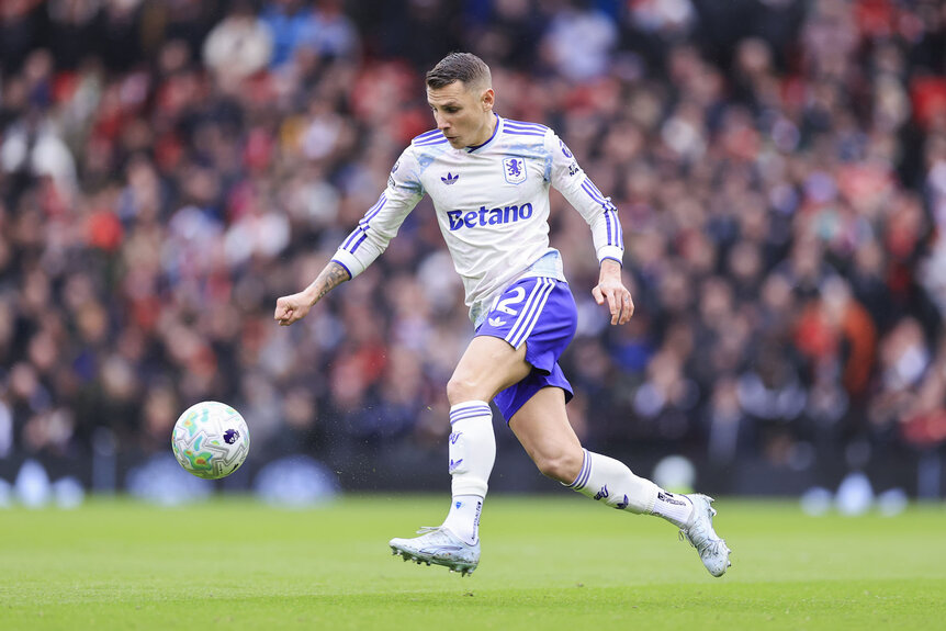 Lucas Digne of Aston Villa kicking a ball during a Premier League match.