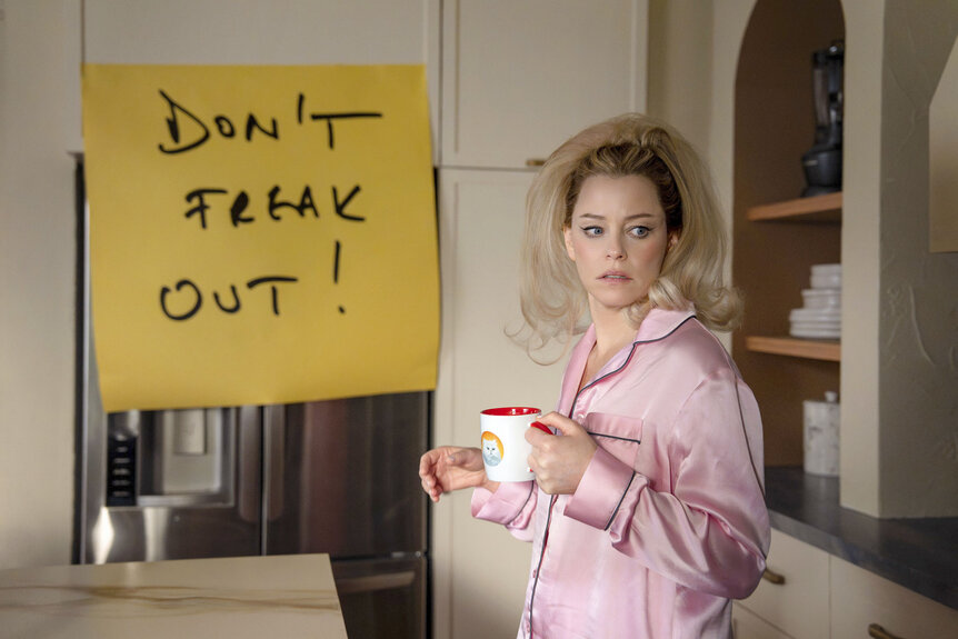 Lindy (Elizabeth Banks) holds a coffee mug in The Miniature Wife Season 1.