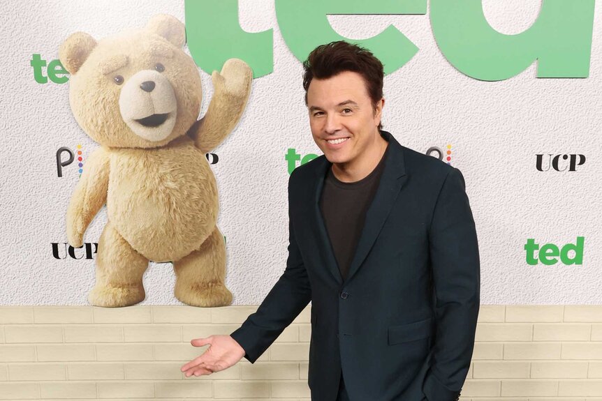 Seth MacFarlane pointing at ted at the ted premiere for Season 1.