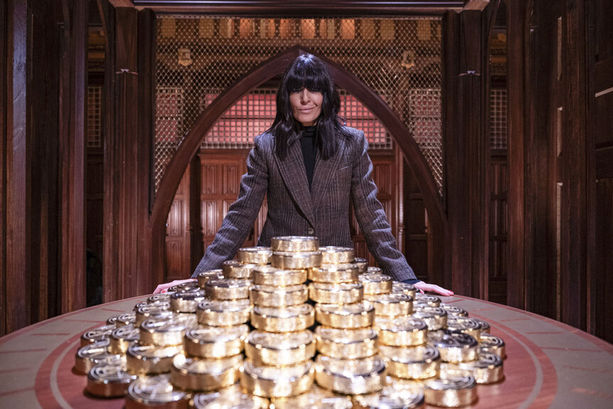 Claudia Winkleman posing with gold in The Traitors UK Season 3 Epsiode 1.