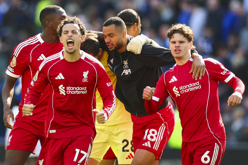 Curtis Jones of Liverpool celebrates with teammates after a Premier League match.
