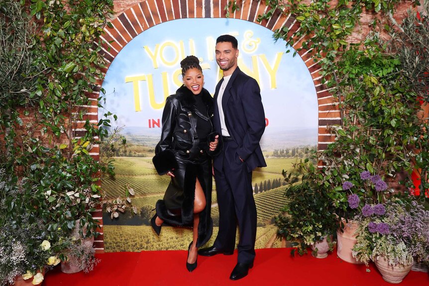Halle Bailey and Regé-Jean Page hugging and posing at a screening of You, Me & Tuscany.