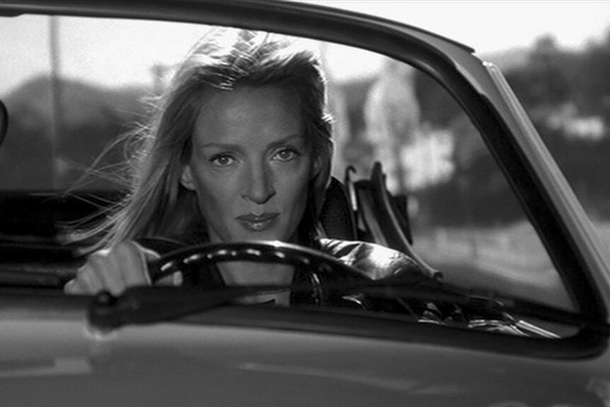 Uma Thurman driving in Kill Bill: The Whole Bloody Affair (2004).