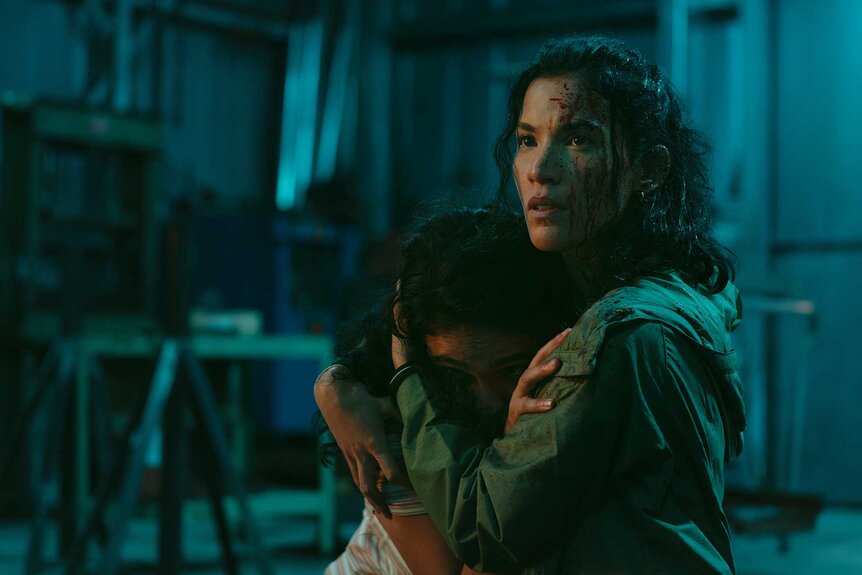 Leah holding someone in M.I.A. Season 1 Episode 2.&nbsp;