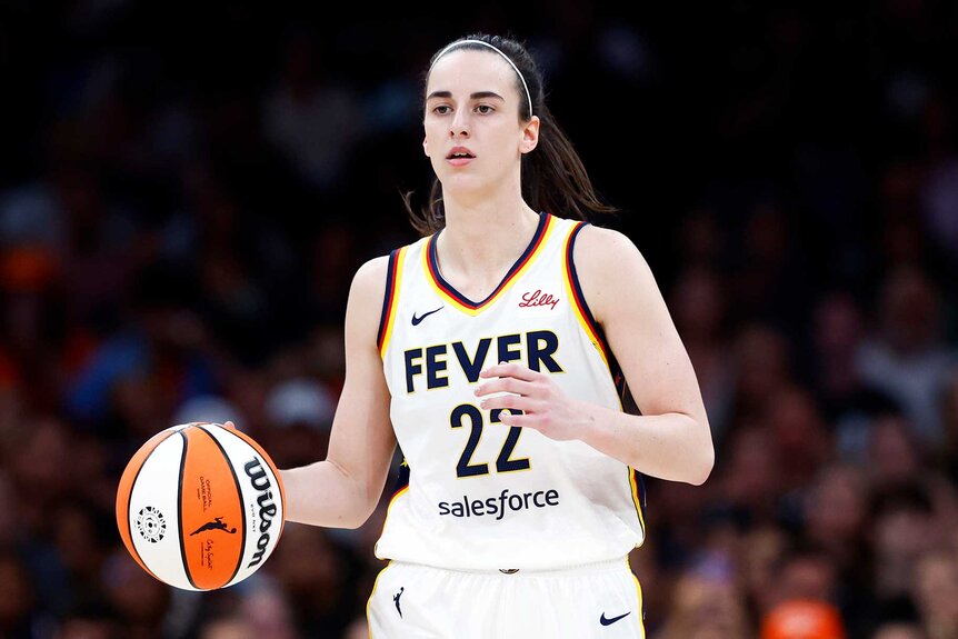 Caitlin Clark of Indiana Fever dribbles during the first quarter of a game.