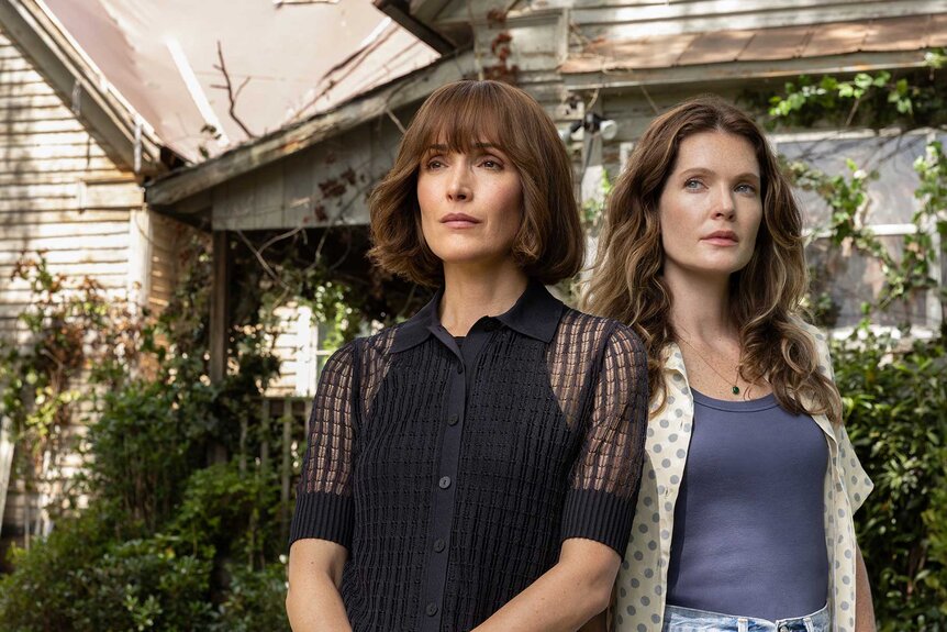 Samantha and Charlotte standing next to each other outside a home in The Good Daughter Season 1.