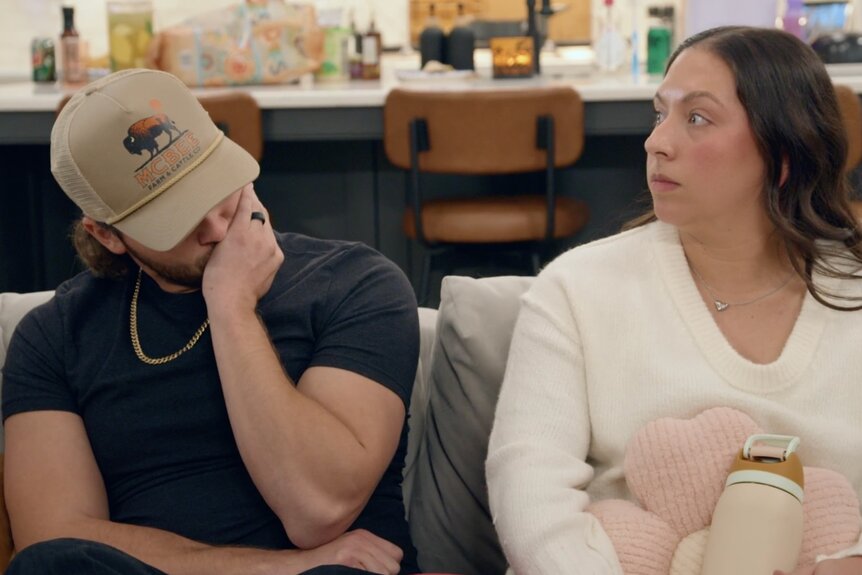 Jesse McBee and Allie McBee sitting next together on a couch during McBee Dynasty Season 3.