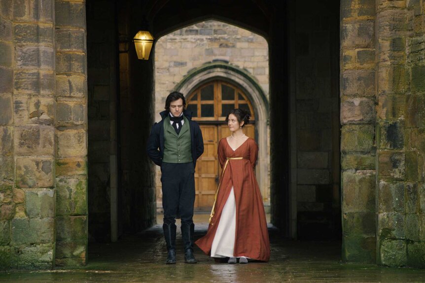 Adam Boyce, Duke of Kielder, walking with Persephone Lancaster through an arch way in Seeking Persephone Season 1.