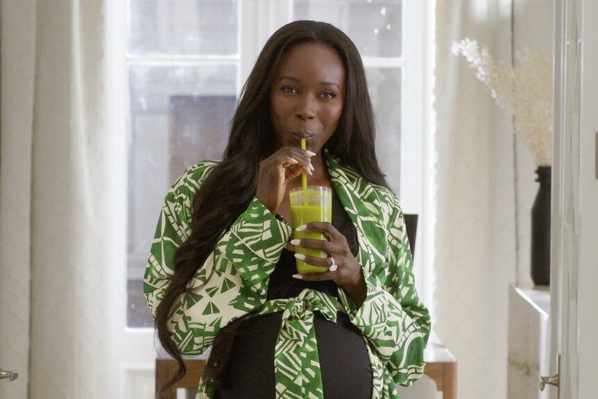 Anna Diop taking a sip of a drink during the film Strung (2026).