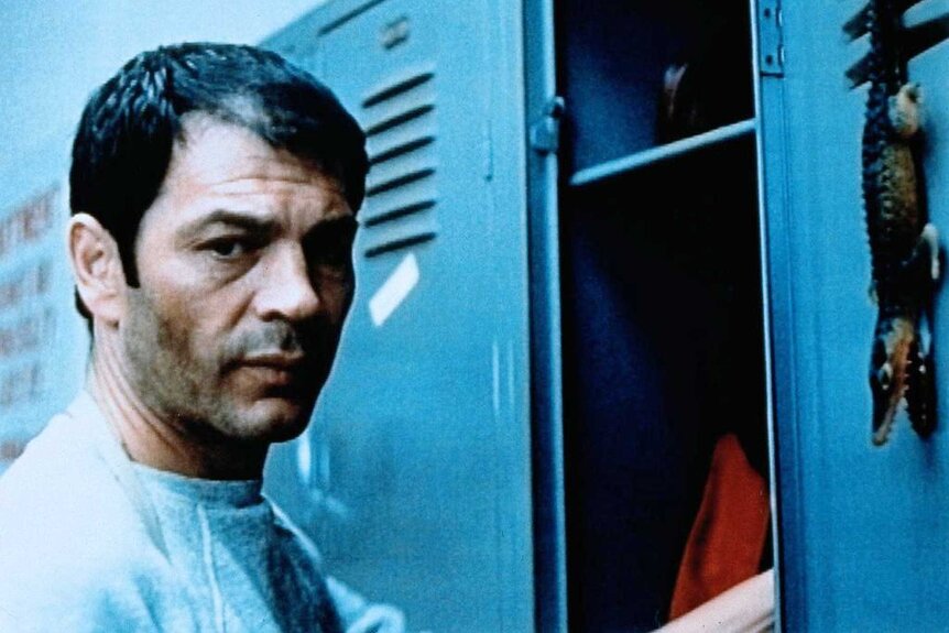 David Madison standing in a locker room in Alligator (1980).