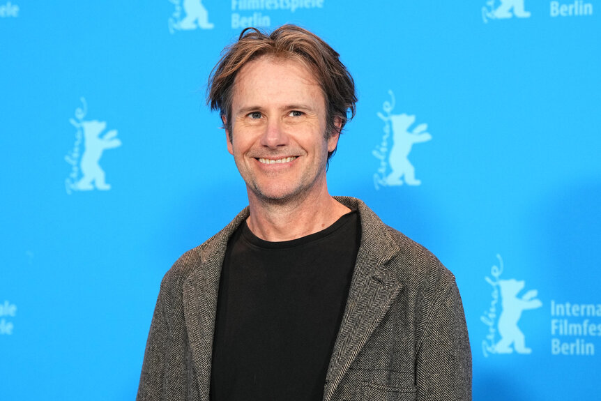 Josh Hamilton stands in front of the blue wall during the photocall for the film "Reality".