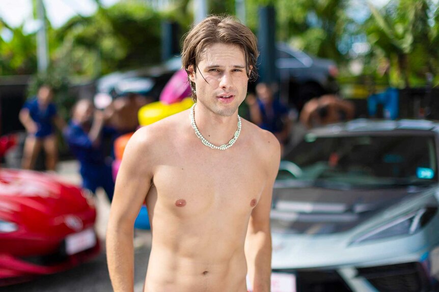 Bryce Alakai Dettloff standing by cars on Love Island USA Season 8.