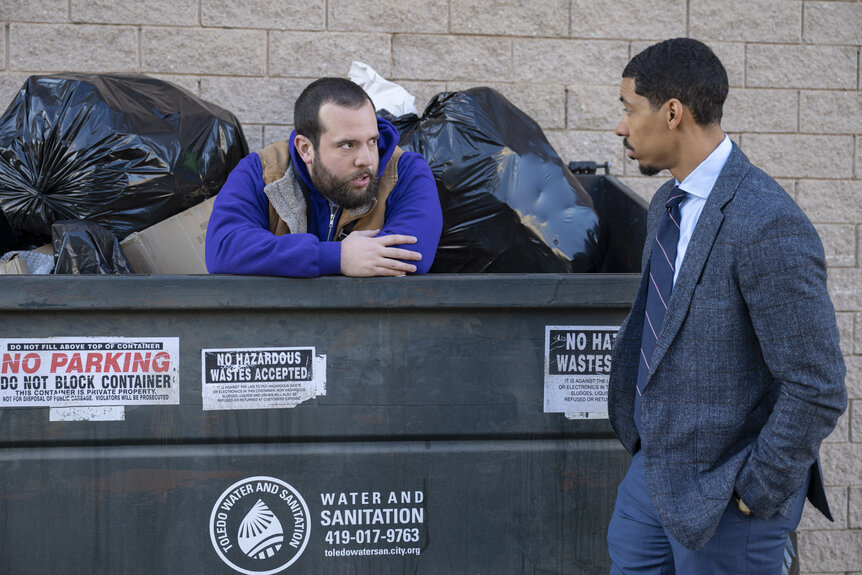 Travis (Eric Rahill) and Detrick (Melvin Gregg) standing by a dumpster in The Paper Season 2 Episode 4.