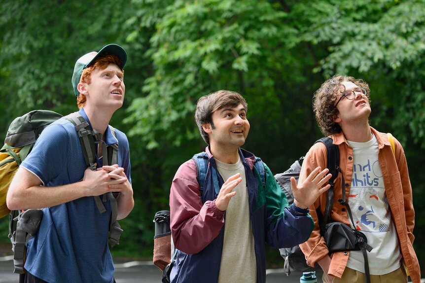 Ben Marshall, John Higgins, and Martin Herlihy looking up in a forest in Please Don't Destroy: The Treasure of Foggy Mountain (2025).