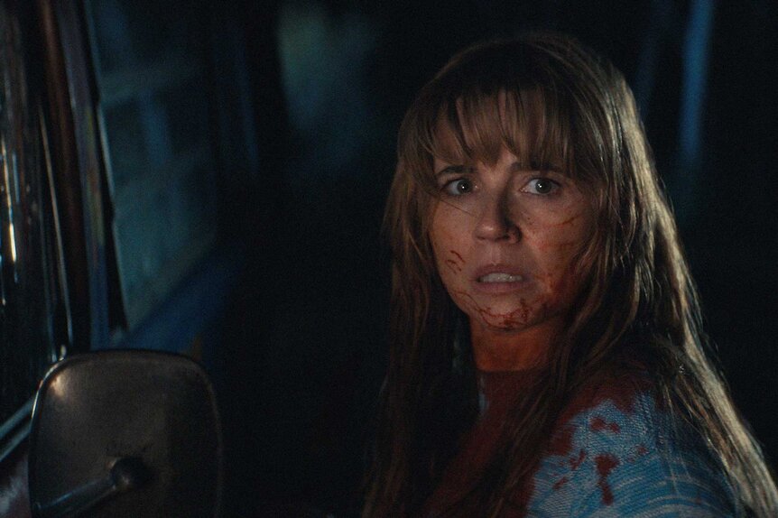 A close up of Pamela Voorhees with a fearful look in Crystal Lake Season 1.