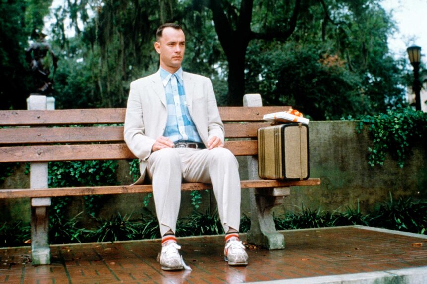 Forrest Gump sitting on a bench in Forrest Gump (1994).