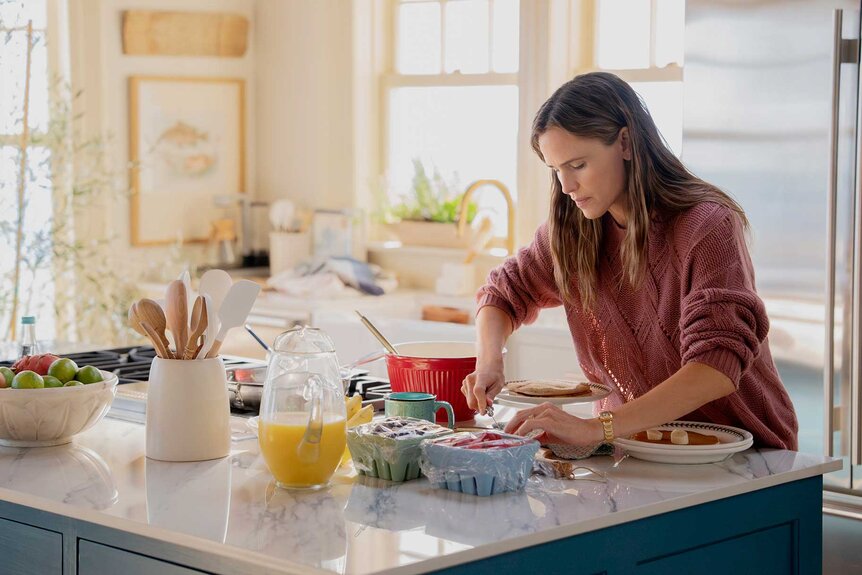 Hollis making breakfast in her kitchen in The Five Star Weekend Season 1.
