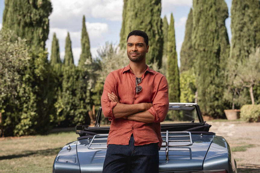 Michael (Regé-Jean Page) leaning on a car in You, Me & Tuscany (2026).