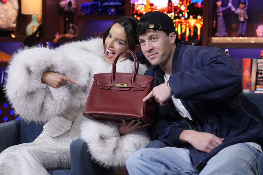 Maura Higgins and Rob Rausch posing with a birkin bag at the WWHL clubhouse.