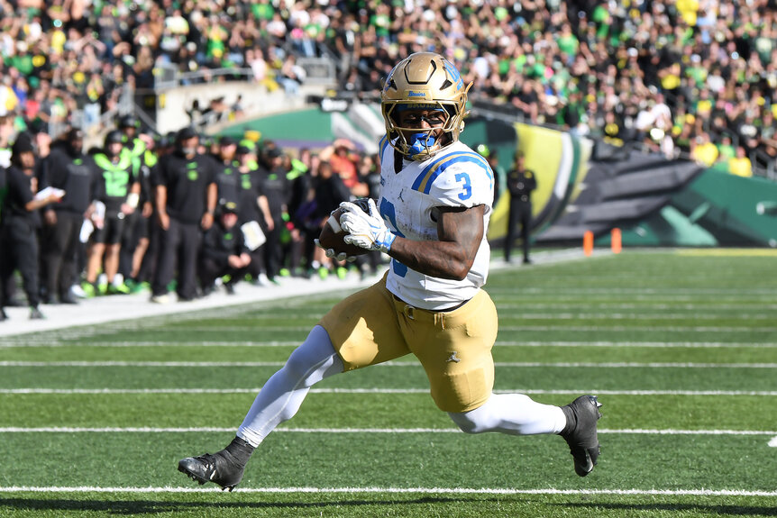 UCLA Bruins running back Wayne Knight carries the football while running across the field during a game against the Oregon Ducks.