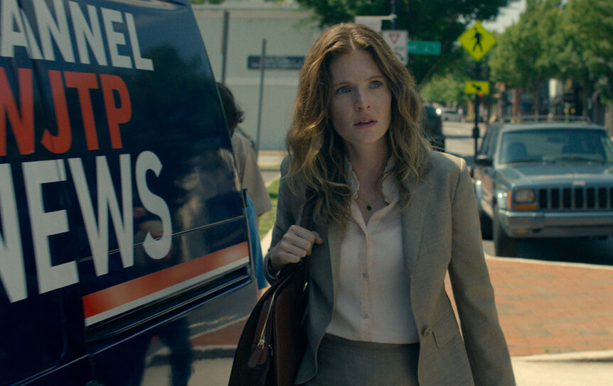 Meghann Fahy as Charlie standing in front of a news van on The Good Daughter Season 1.
